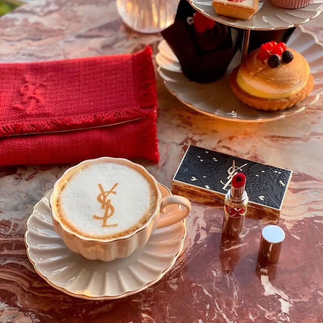 Kaffeedrucker Ergebnis: YSL-Logo auf Latte-Schaum neben YSL-Lippenstift und Gebäck